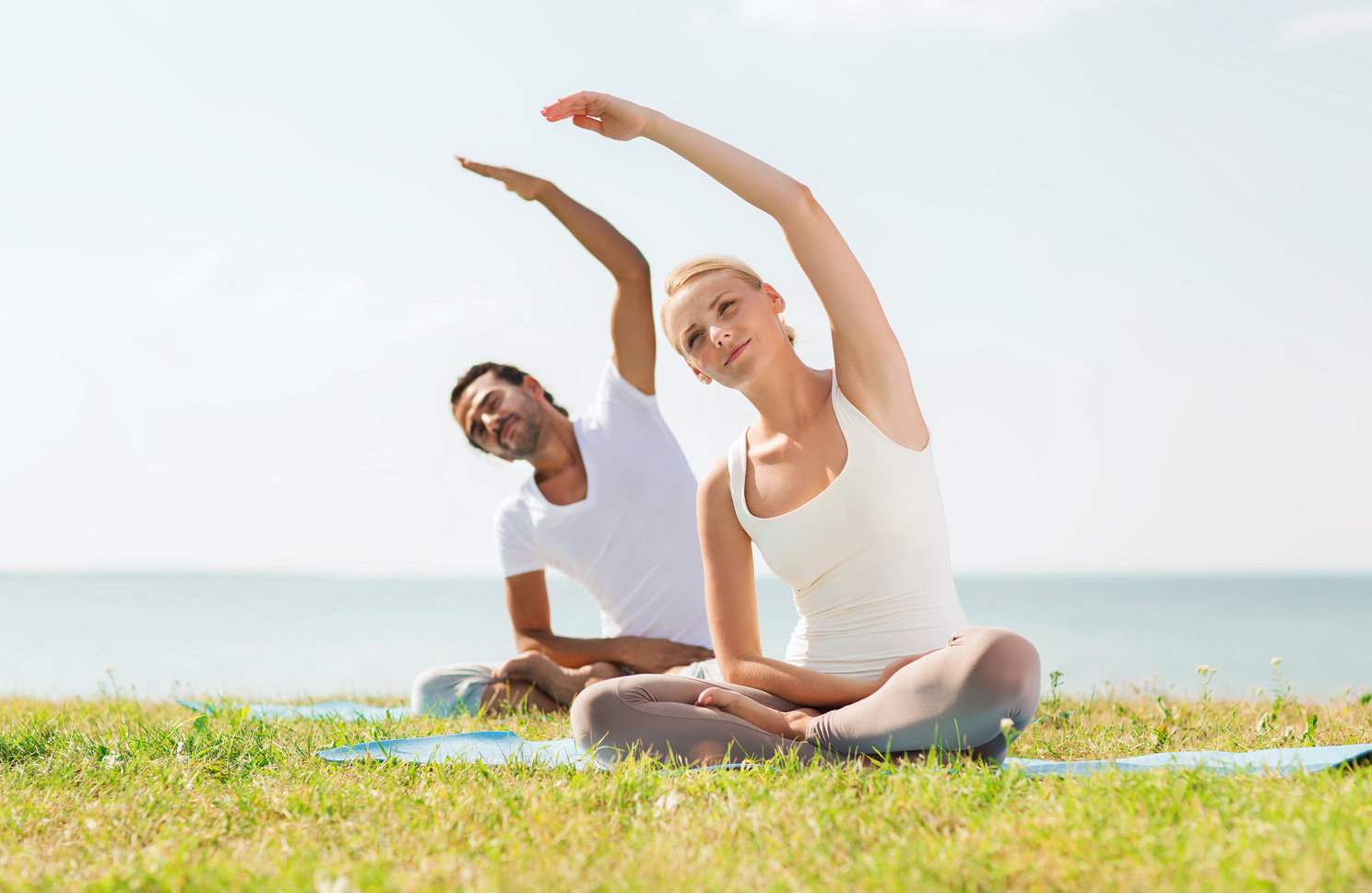 Couple Doing Yoga Exercises 