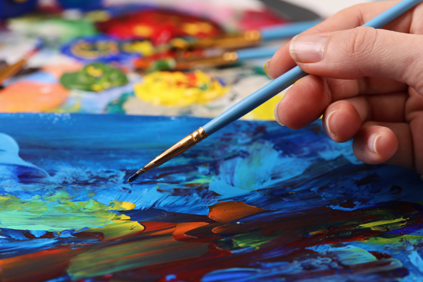 Artist hand with brush painting picture close up. Art, creativity, hobby concept, Anti stress art therapy .